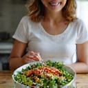 A person happily eating a salad, symbolizing weight management and healthy eating habits.
